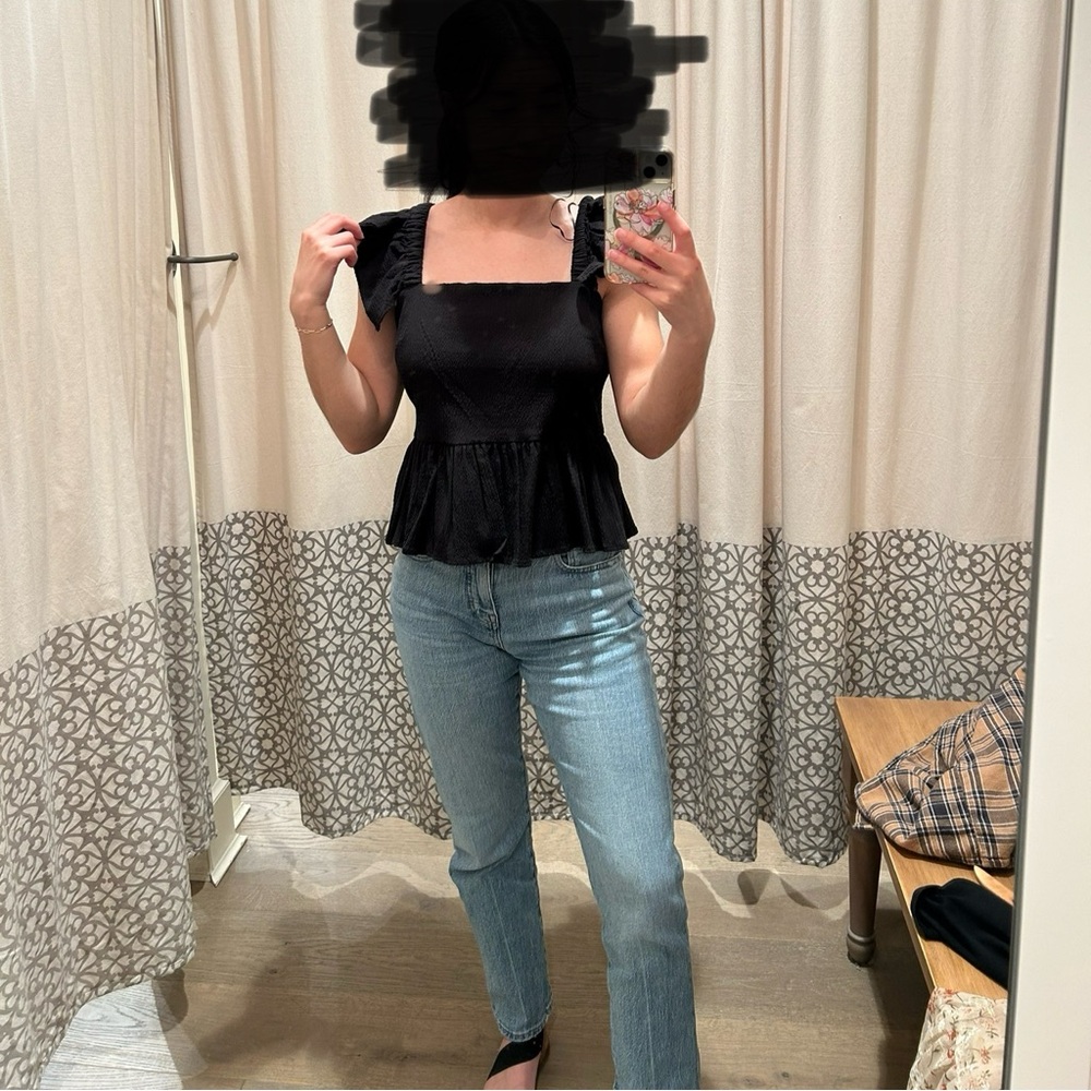 Francesca’s black open back tied shirt. Frilly